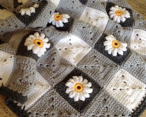  9. Gingham And Daisies Crochet Blanket Pattern by Lullaby Lodge